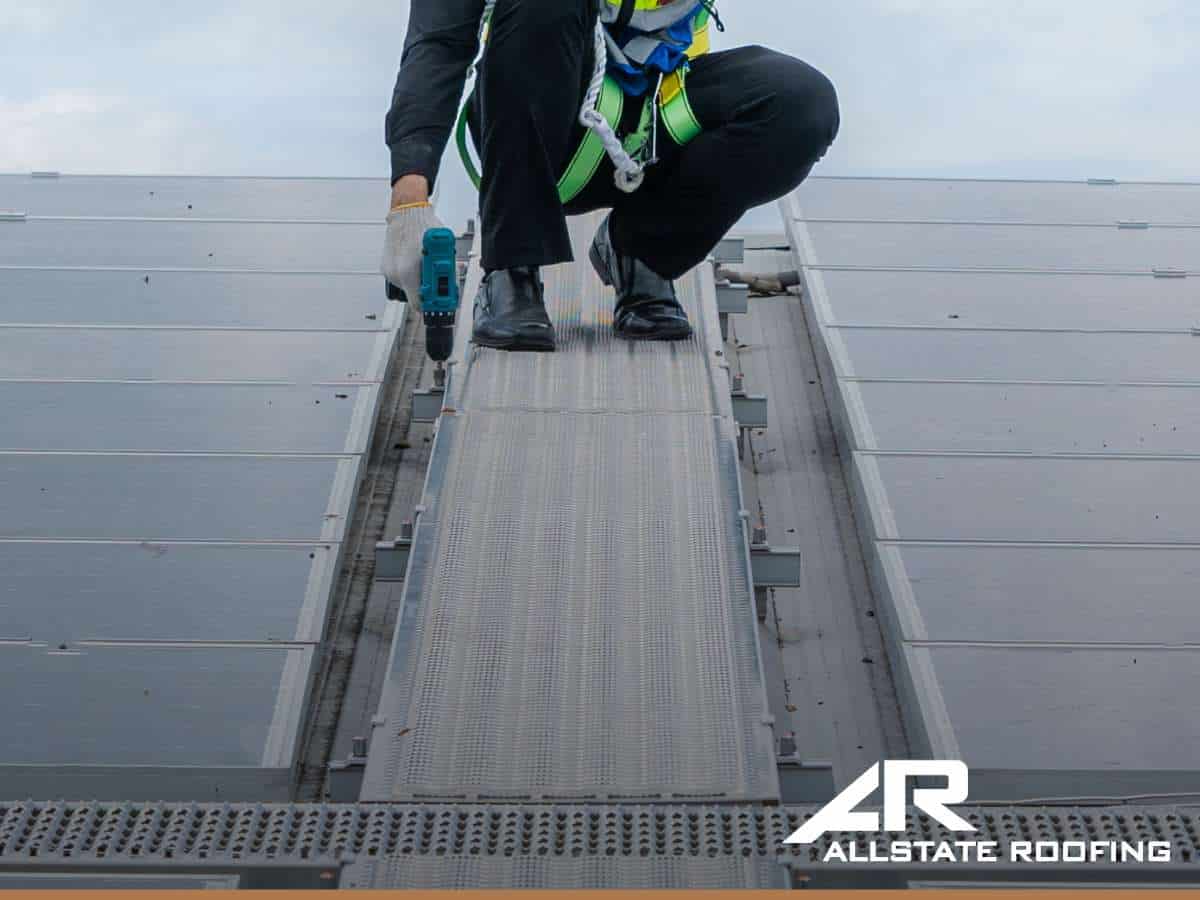 Technician performing maintenance on a commercial roofing system